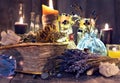 Old witch book with lavender flowers, crystal and evil candles