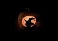 Witches silhouette on the Halloween pumpkin on black Royalty Free Stock Photo