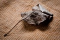 An old, withered twisted leaf from a tree, photographed on a cracked wooden surface. Symbolizes the old and the frailty of