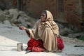 Old woman asks charity on the street