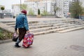 Old woman with bags in Chisinau, Moldova