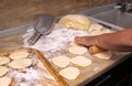 Old woman baking pies in her home kitchen. Grandma cooks pies. Home cooked food. omemade mold cakes of the dough in the ederly wom Royalty Free Stock Photo