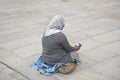 Old woman beggar sitting begging money from people