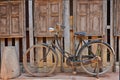 Old woman bicycle beside the windows of storage warehouse Royalty Free Stock Photo