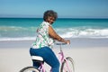 Old woman with a bike at the beach Royalty Free Stock Photo