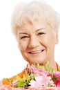 An old woman with bouquet of flowers. Royalty Free Stock Photo