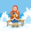 An old woman with a cat sitting on a bench in a winter Park Royalty Free Stock Photo