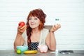 Old woman choose apple or pill bottle Royalty Free Stock Photo