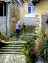 An old woman climbing the stairs Royalty Free Stock Photo