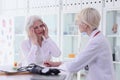 Old woman complains on strong migraine to doctor in hospital Royalty Free Stock Photo