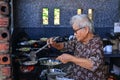 An old woman cooking Vietnamese pancake