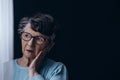 Old woman in dark room Royalty Free Stock Photo