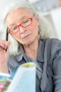 Old woman doing a crossword Royalty Free Stock Photo