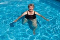 Old Woman doing exercises in a pool. She is smiling Royalty Free Stock Photo