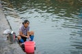 Old woman doing laundry in Fenghuang