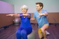 Old woman doing physical therapy on ball Royalty Free Stock Photo