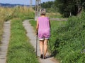 Old woman doing sports: scandinavian/nordic walking. Healthy lifestyle. A personal example of society. Healthy and active lifesty