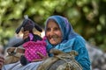 Old woman with a donkey and plaything Royalty Free Stock Photo