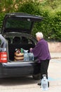 Old woman downloading the car Royalty Free Stock Photo