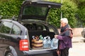 Old woman downloading the car Royalty Free Stock Photo