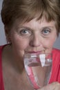 Old woman drinking mineral water Royalty Free Stock Photo