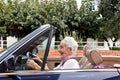 Old woman driving a convertible
