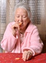 Old woman eating tangerine Royalty Free Stock Photo