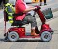 Old woman with an electirc wheelchair on the street Royalty Free Stock Photo