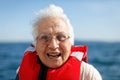 Old woman enjoys a boat ride