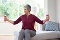 Old woman exercising with dumbbells