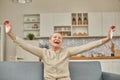 An elderly woman experiences the joy of being at home with her arms wide open. Happy pensioner concept Royalty Free Stock Photo