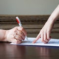 An old woman is forced to write a will for an apartment Royalty Free Stock Photo