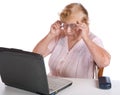 The old woman in glasses looks at notebook Royalty Free Stock Photo