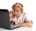 The old woman in glasses looks at the notebook Royalty Free Stock Photo