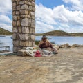 Old woman at habor. Road and boat trip to Isla del Sol, Island o
