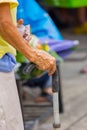 Old woman hand leans on walking stick, close-up Royalty Free Stock Photo