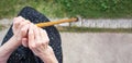 Old woman hands holding a walking cane Royalty Free Stock Photo