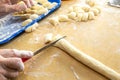 Old woman hands preparing fresh italian pasta gnocchi. Concept Italian Traditional cuisine Royalty Free Stock Photo