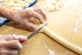 Old woman hands preparing fresh italian pasta gnocchi. Concept Italian Traditional cuisine Royalty Free Stock Photo