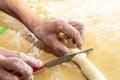 Old woman hands preparing fresh italian pasta gnocchi. Concept Italian Traditional cuisine Royalty Free Stock Photo