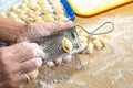 Old woman hands preparing fresh italian pasta gnocchi. Concept Italian Traditional cuisine Royalty Free Stock Photo