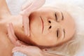 An old woman is having a face massgae. Spa concept. Royalty Free Stock Photo