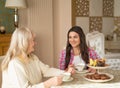 Old woman is having tea with a daughter Royalty Free Stock Photo