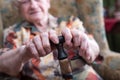 Old woman with her hands on a cane Royalty Free Stock Photo