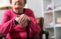 Old woman with her hands on a cane Royalty Free Stock Photo