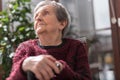 Old woman with her hands on a cane Royalty Free Stock Photo