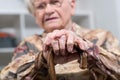 Old woman with her hands on a cane Royalty Free Stock Photo