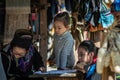 The old woman of Hmong tribe name is painting on to the white fabric