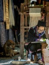 The old woman of Hmong tribe name is painting on to the white fabric