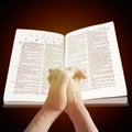 Old woman holding a bible in her hands and praying Royalty Free Stock Photo